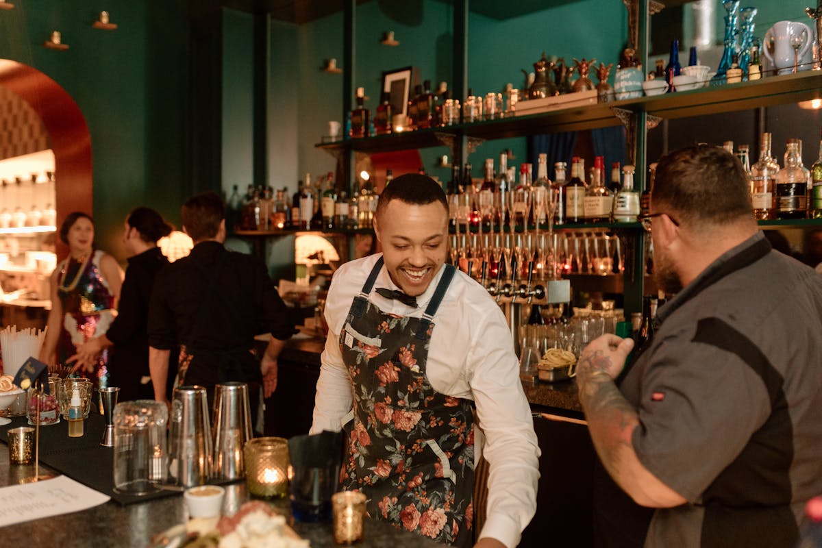 The bar at Mr. Paul's Supper Club during service, bartender mixing drinks